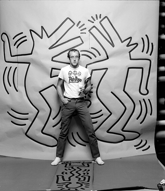 Keith Haring photographed with one of his paintings in April 1984. Image: © Jack Mitchell/Getty Images